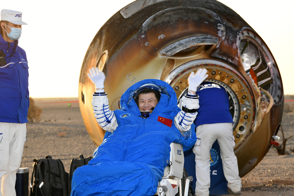 In this photo released by Xinhua News Agency, Wang Jie, a Shenzhou-20 astronaut, returns on the Shenzhou-21 spaceship's return capsule after it touched down on Earth at the Dongfeng landing site in north China's Inner Mongolia Autonomous Region, Friday, Nov. 14, 2025. (Wang Jiangbo/Xinhua via AP)