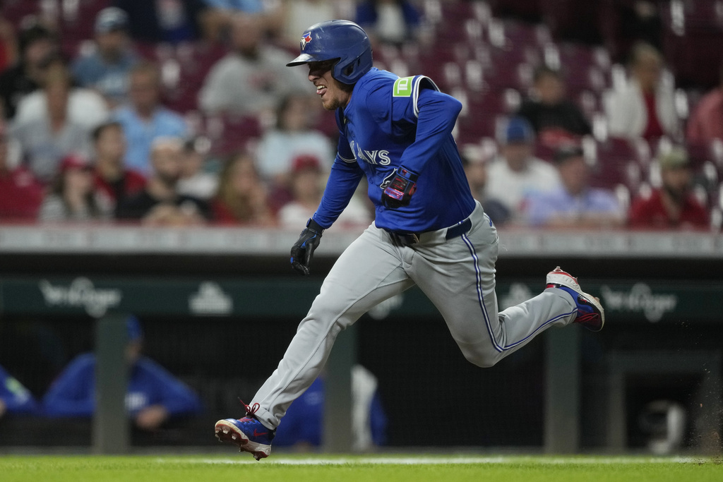 Toronto Blue Jays' Myles Straw runs to home plate to score on a sacrifice fly hit by Daulton Varsho during the eighth inning of a baseball game against the Cincinnati Reds Wednesday, Sept. 3, 2025, in Cincinnati. (AP Photo/Carolyn Kaster)