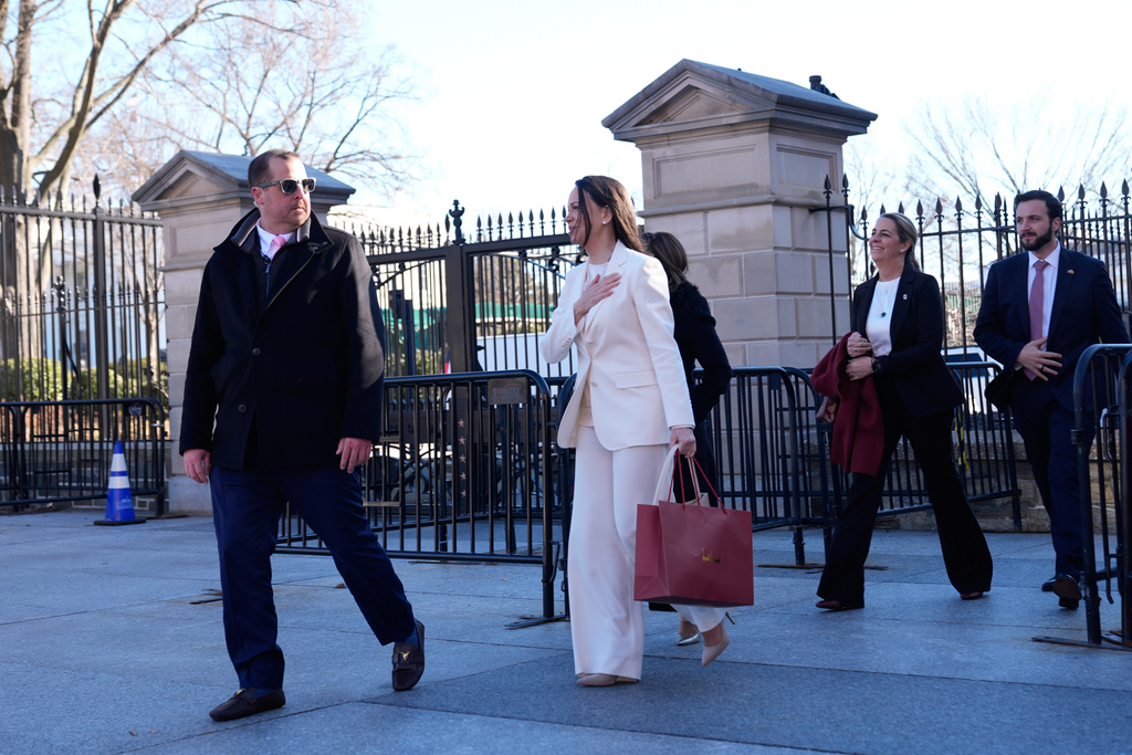 Venezuelan opposition leader María Corina Machado gestures to supporters on Pennsylvania Avenue as she leaves the White House after meeting with President Donald Trump Thursday, Jan. 15, 2026, in Washington. (AP Photo/Pablo Martinez Monsivais)