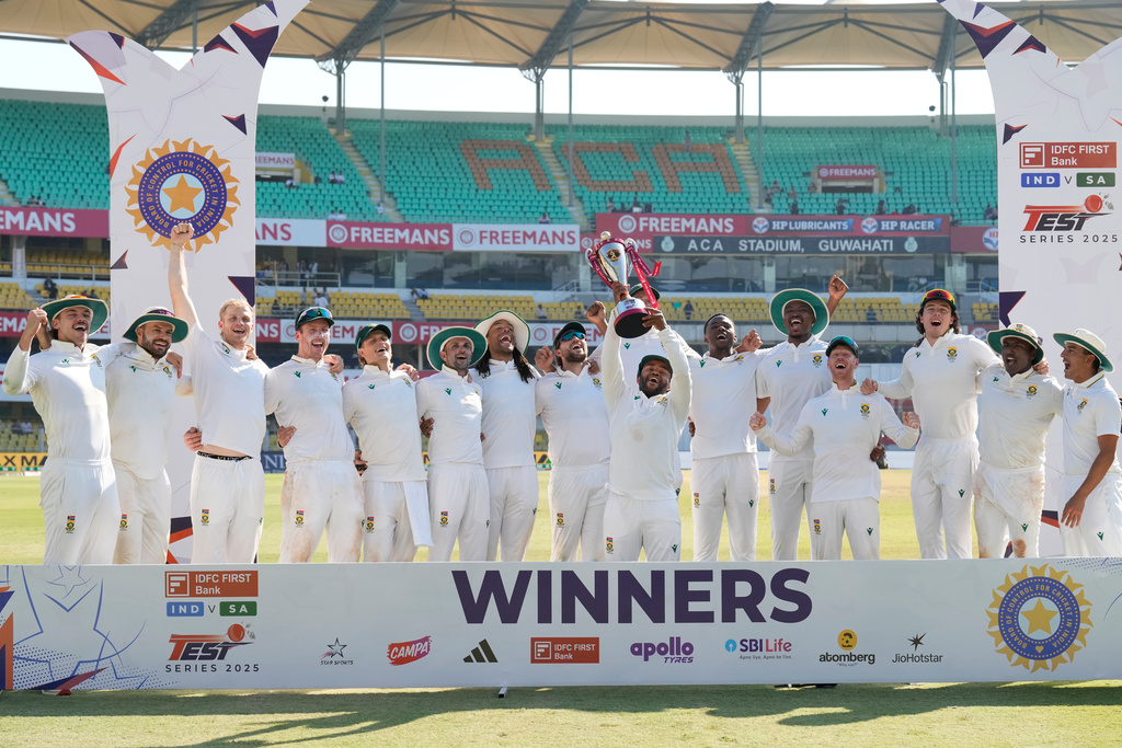 South Africa's cricket team celebrates with the trophy after winning the test series against India in Guwahati, India, Saturday, Nov. 22, 2025. (AP Photo/Anupam Nath)