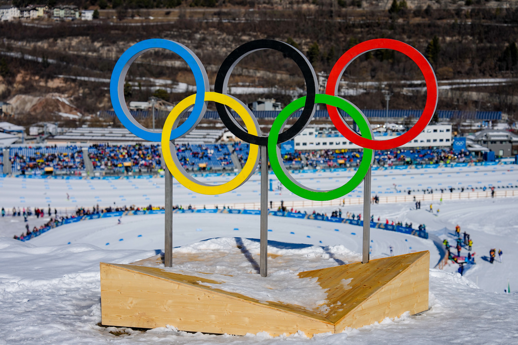 FILE - The Olympic rings stand above the course during the cross country skiing women's 50km mass start classic at the 2026 Winter Olympics, in Tesero, Italy, Feb. 22, 2026. (AP Photo/Matthias Schrader, File)
