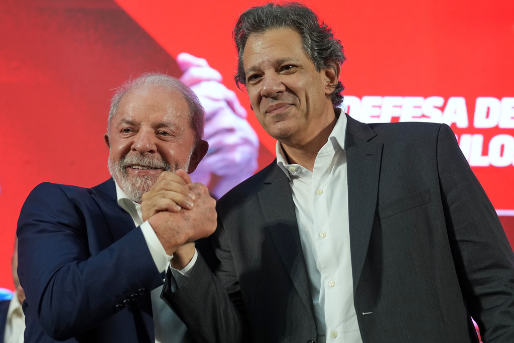 Brazilian President Luiz Inacio Lula da Silva, left, and outgoing Finance Minister Fernando Haddad shake hands during a ceremony announcing Haddad's candidacy for governor of Sao Paulo state in the October elections, in Sao Bernardo do Campo, Brazil, Thursday, March 19, 2026. (AP Photo/Andre Penner)