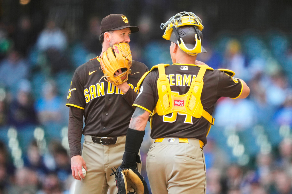 San Diego Padres pitcher Griffin Canning, left, talks with catcher Freddy Fermin, right, during the first inning of a baseball game against the Milwaukee Brewers, Thursday, May 14, 2026, in Milwaukee. (AP Photo/Kayla Wolf)