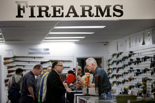 FILE - Sales associate Mike Conway, right, shows Paul Angulo guns at Bullseye Sport gun shop in Riverside, Calif on Wednesday, Dec. 9, 2015, (AP Photo/Jae C. Hong, File) FILE - Sales associate Mike Conway, right, shows Paul Angulo guns at Bullseye Sport gun shop in Riverside, Calif on Wednesday, Dec. 9, 2015, (AP Photo/Jae C. Hong, File)