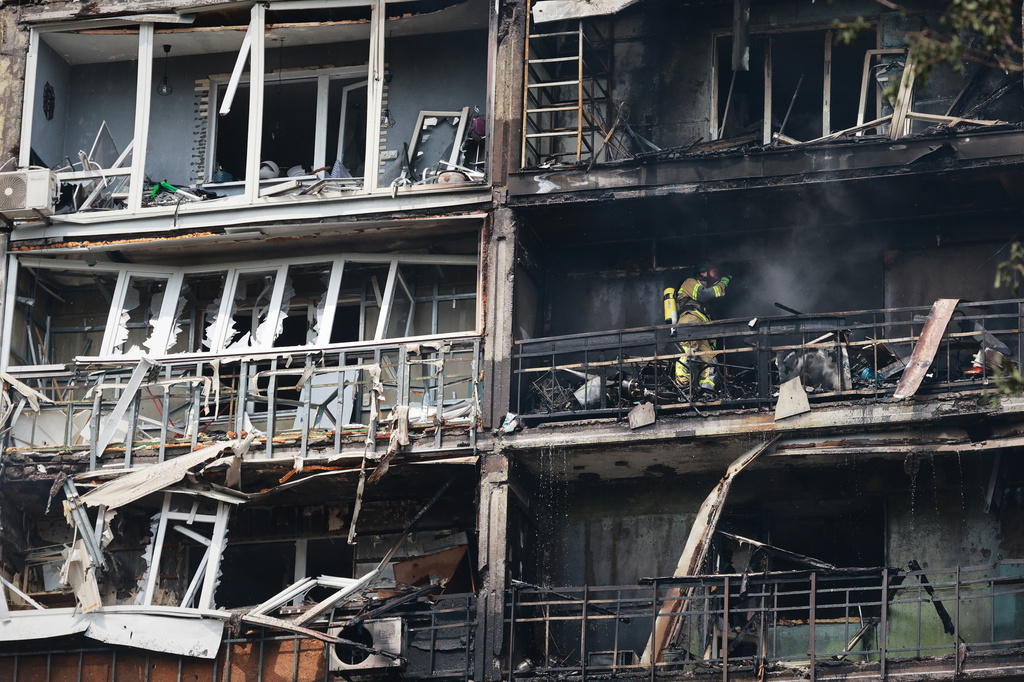Rescuers work at the damaged apartment building following a Russian air guided bomb strike in Zaporizhzhia, Ukraine, Tuesday, July 21, 2026. (AP Photo/Kateryna Klochko)