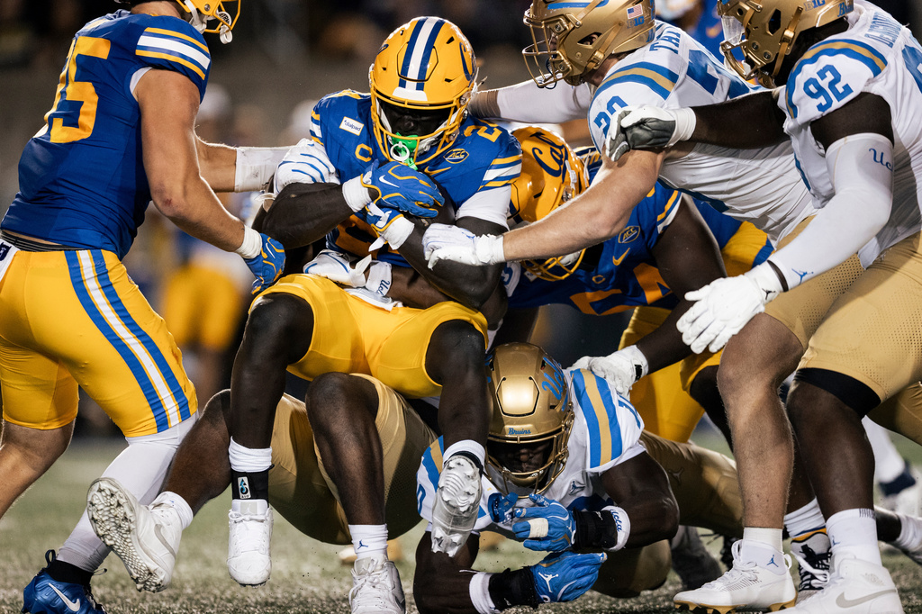 California running back Adam Mohammed (24) is being tackled at the line of scrimmage during the first half of an NCAA football game against UCLA in Berkeley, Calif., on Saturday, Sept. 5, 2026. (Stephen Lam/San Francisco Chronicle via AP)