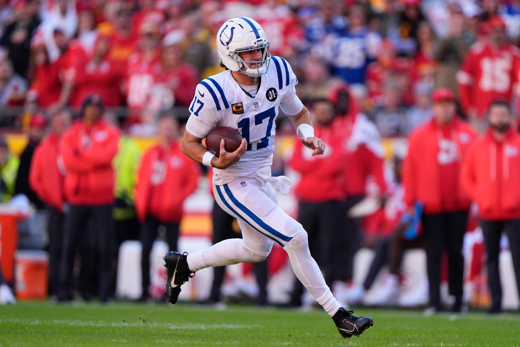Indianapolis Colts quarterback Daniel Jones (17) runs for a first down against the Kansas City Chiefs during the second half of an NFL football game Sunday, Nov. 23, 2025, in Kansas City, Mo. (AP Photo/Charlie Riedel)