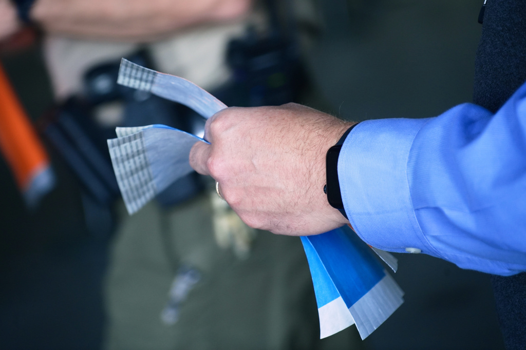Court staff hands out wristbands for limited public seating at a preliminary hearing for Tyler Robinson, the Utah man accused of fatally shooting Charlie Kirk, Tuesday, July 7, 2026, in Provo, Utah. (AP Photo/Ty ONeil)