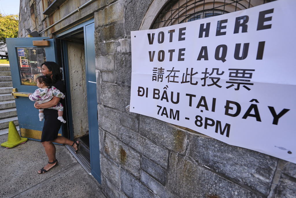 Boston Mayor Michelle Wu carries her daughter Mira after voting at a polling place, Tuesday, Sept. 9, 2025, in the Roslindale neighborhood of Boston. (AP Photo/Charles Krupa)
