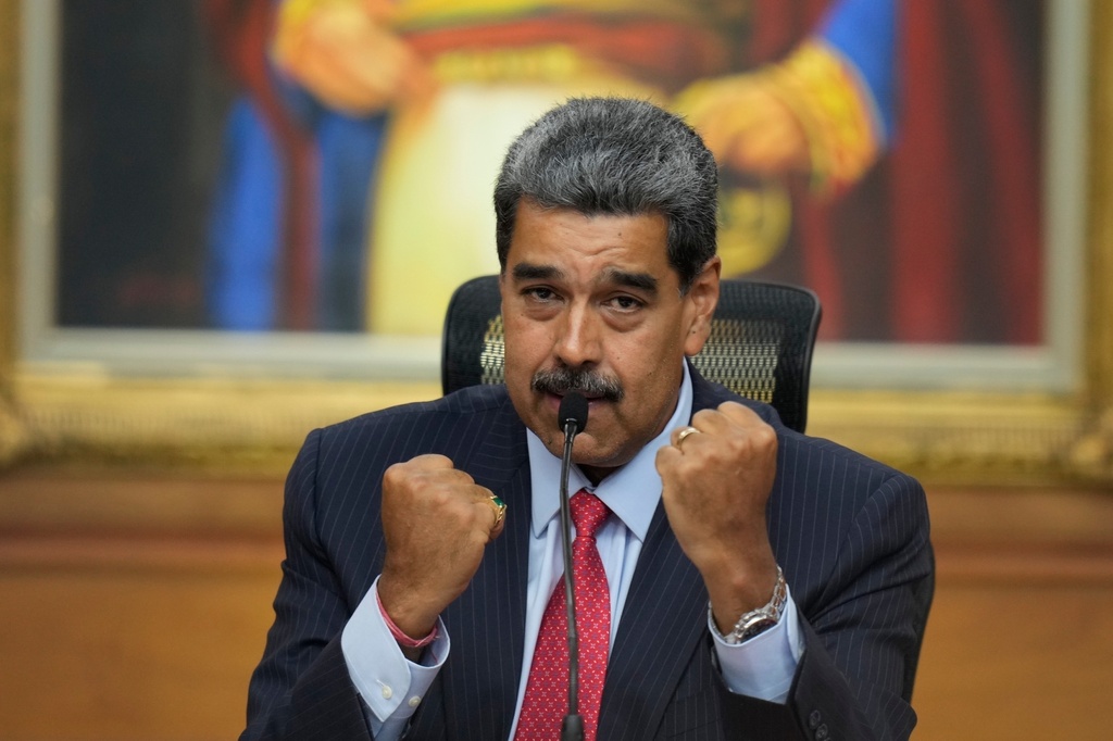 FILE - Venezuelan President Nicolas Maduro raises up his closed fists during a news conference at Miraflores presidential palace in Caracas, Venezuela, July 31, 2024, three days after his disputed reelection. (AP Photo/Matias Delacroix, File)