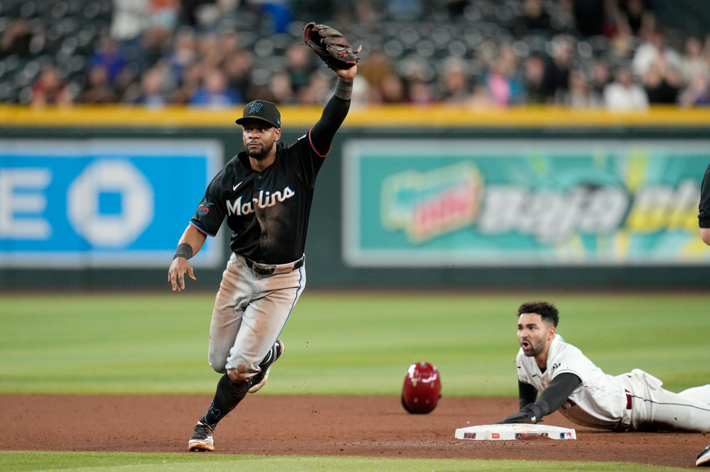 Miami Marlins shortstop Otto Lopez, left, celebrates after tagging out Arizona Diamondbacks' Jordan Lawlar during the ninth inning of a baseball game, Wednesday, Sept. 16, 2026, in Phoenix. (AP Photo/Ross D. Franklin)