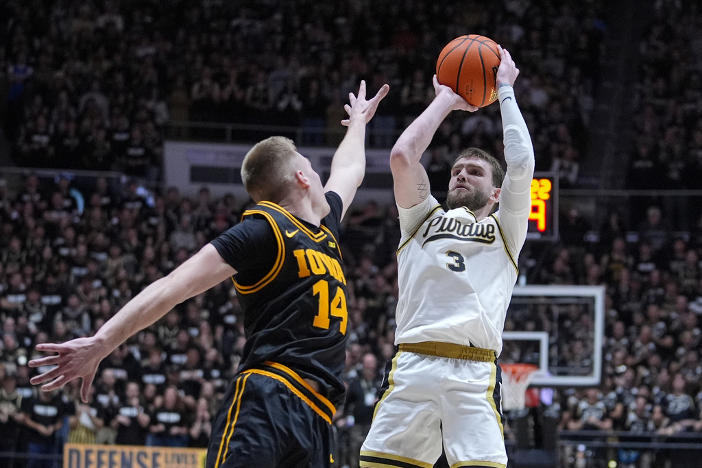 Purdue guard Braden Smith (3) shoots over Iowa guard Bennett Stirtz (14) during the second half of an NCAA college basketball game in West Lafayette, Ind., Wednesday, Jan. 14, 2026. (AP Photo/Michael Conroy)