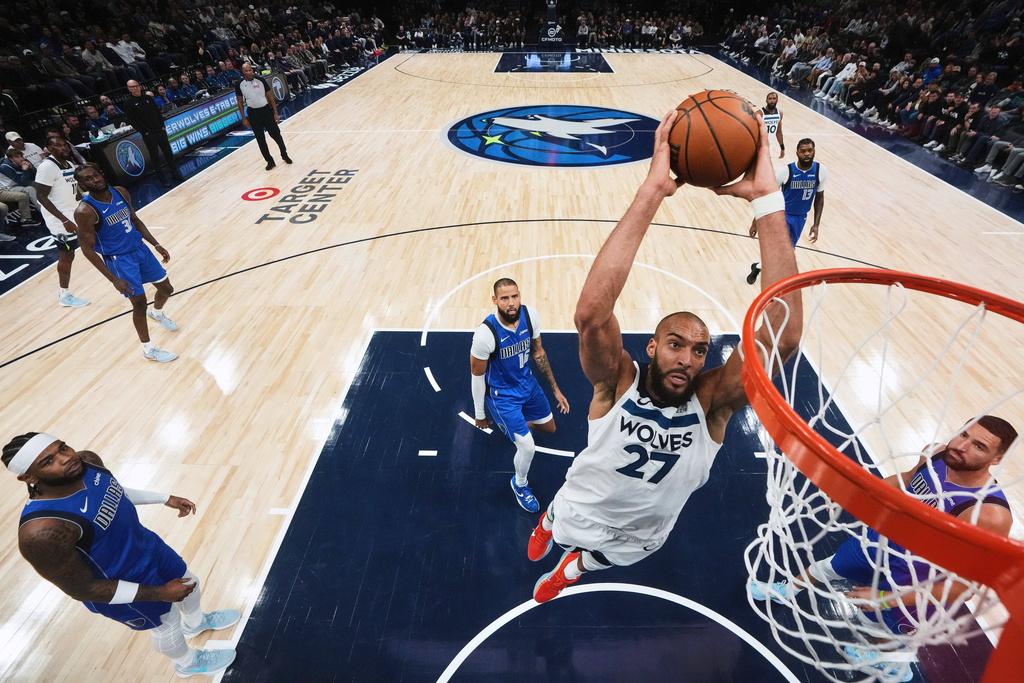 Minnesota Timberwolves center Rudy Gobert (27) goes up to dunk during the second half of an NBA basketball game against the Dallas Mavericks, Monday, Nov. 17, 2025, in Minneapolis. (AP Photo/Abbie Parr)