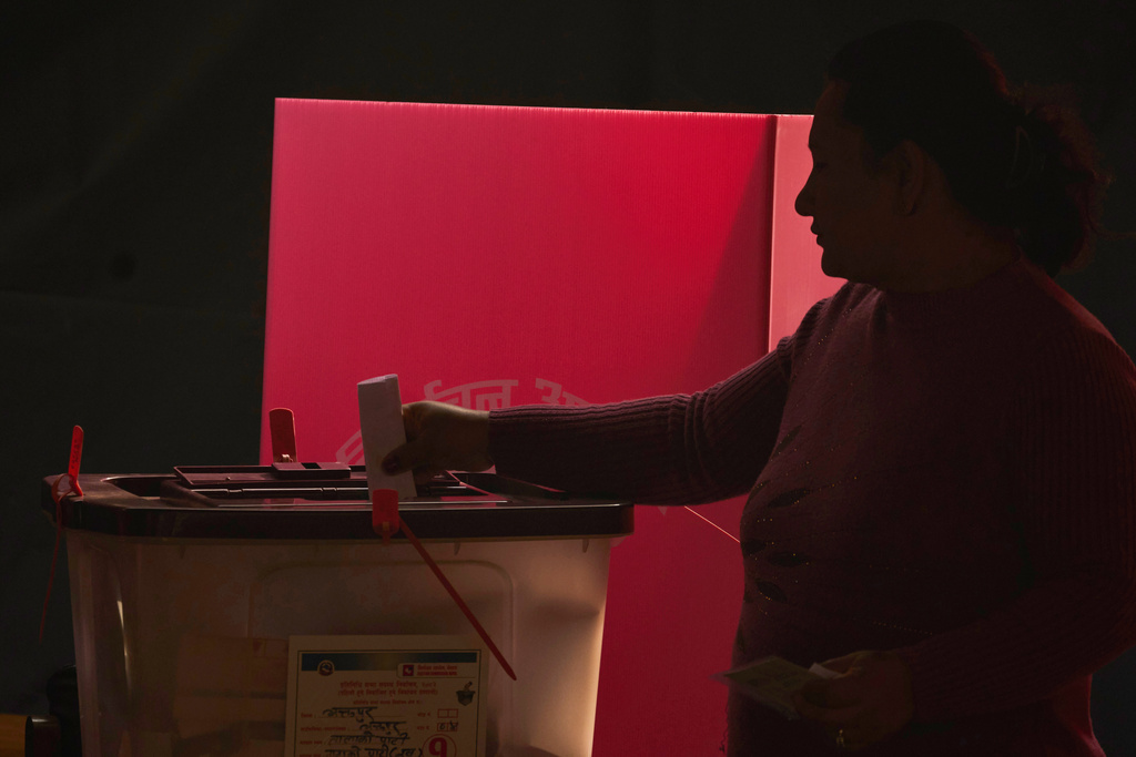 A Nepalese woman casts her vote at polling station for the parliamentary election in Bhaktapur, Nepal, Thursday, March 5, 2026. (AP Photo/Niranjan Shrestha)