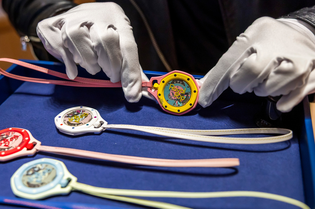 A saleswoman shows the new Royal Pop watch by Swatch and Audemars Piguet, in Geneva, Switzerland, Saturday, May 16, 2026. (Salvatore Di Nolfi/Keystone via AP)