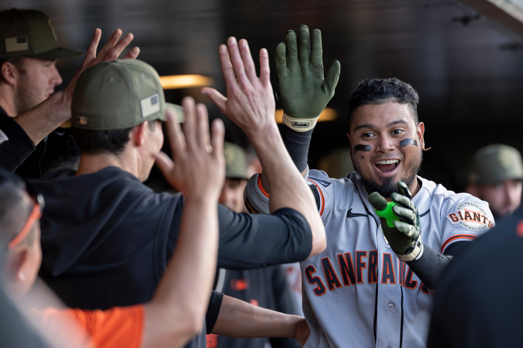 San Francisco Giants' Luis Arraez, right, celebrates after hitting a home run during the fourth inning of a baseball game against the Athletics, Friday, May 15, 2026, in West Sacramento, Calif. (AP Photo/Sara Nevis)