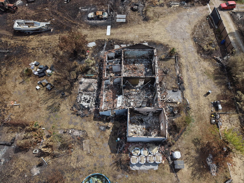 An aerial view of a homes burned by wildfires in Le Porge, southwestern France, Saturday, Aug. 1, 2026. (AP Photo/Nicolas Garriga)