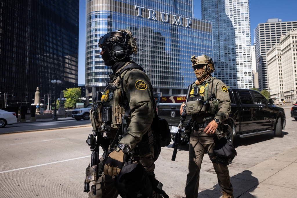 Federal agents from U.S. Immigration and Customs Enforcement and U.S. Customs and Border Protection walk along West Wacker Drive in the Loop, Sunday, Sept. 28, 2025, in Chicago. (Ashlee Rezin/Chicago Sun-Times via AP)