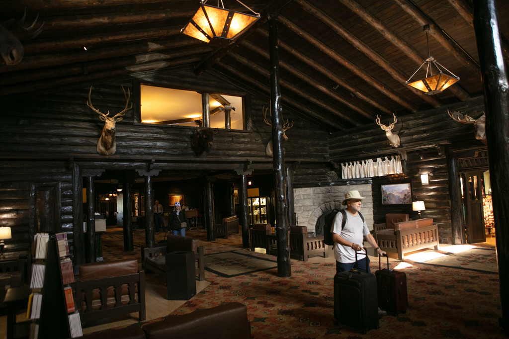 Tourists check out of the El Tovar Hotel as lodging along the rim of the canyon was shut down due to flooding, Monday, Aug. 31, 2026 at Grand Canyon National Park, Ariz. (AP Photo/Josh Biggs)