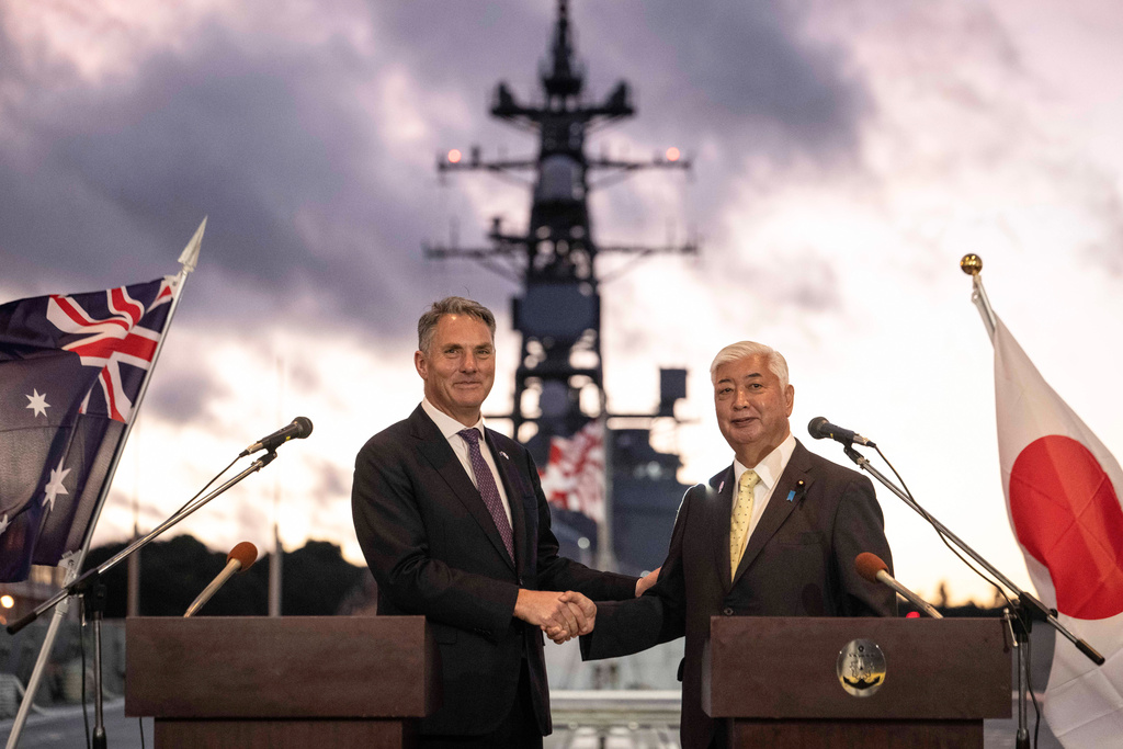 Japan's Defence Minister Gen Nakatani, right, and Australia's Defence Minister Richard Marles shake hands following a joint press announcement aboard the Japan Maritime Self-Defense Force (JMSDF) Mogami-class stealth frigate JS Mikuma at the JMSDF naval base in Yokosuka, Japan, Friday Sept. 5, 2025. (Yuichi Yamazaki/Pool Photo via AP)