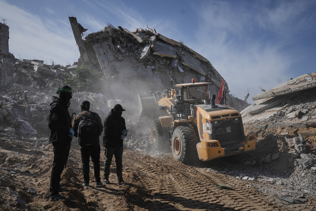 Islamic Jihad and Hamas militants search for the remains of deceased hostages in Beit Lahiya, northern Gaza Strip Wednesday, Dec. 3, 2025. (AP Photo/Jehad Alshrafi)