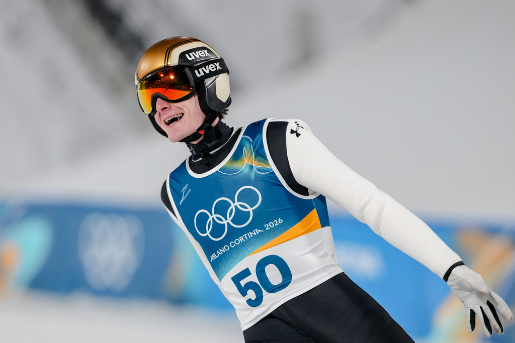 Domen Prevc, of Slovenia, reacts after his final round jump of the ski jumping men's large hill individual at the 2026 Winter Olympics, in Predazzo, Italy, Saturday, Feb. 14, 2026. (AP Photo/Kirsty Wigglesworth)
