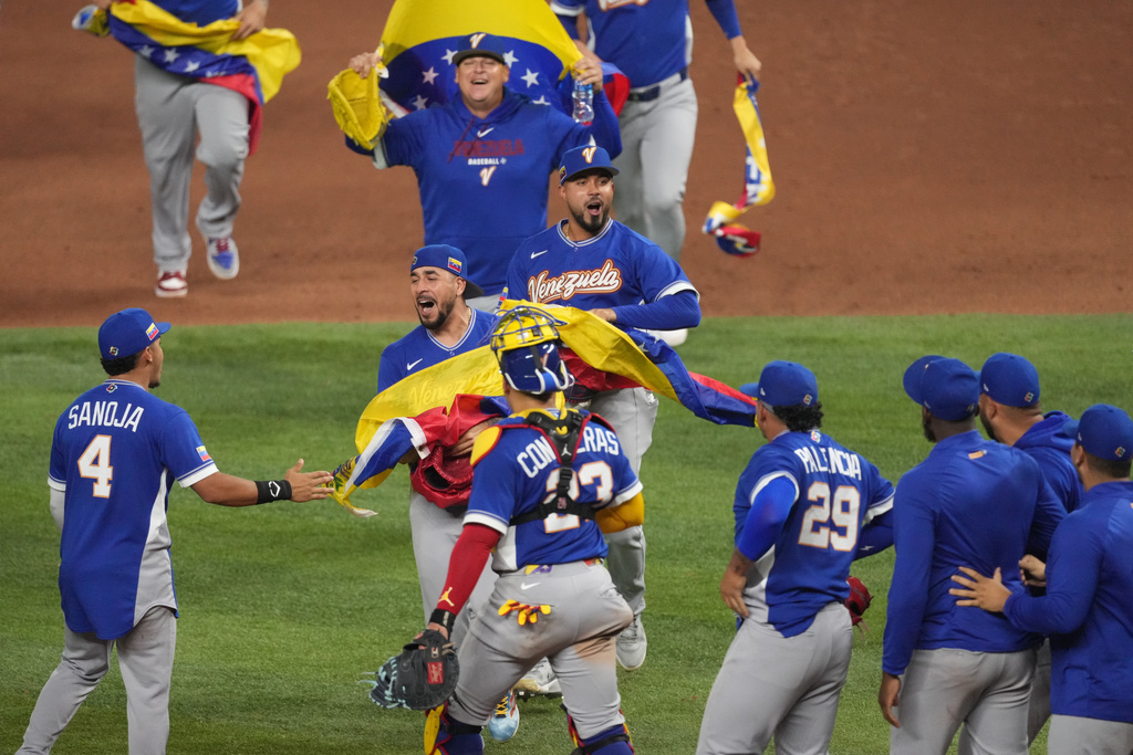 The Venezuela team celebrates after defeating Italy at a World Baseball Classic semifinal game, Monday, March 16, 2026, in Miami. (AP Photo/Lynne Sladky)