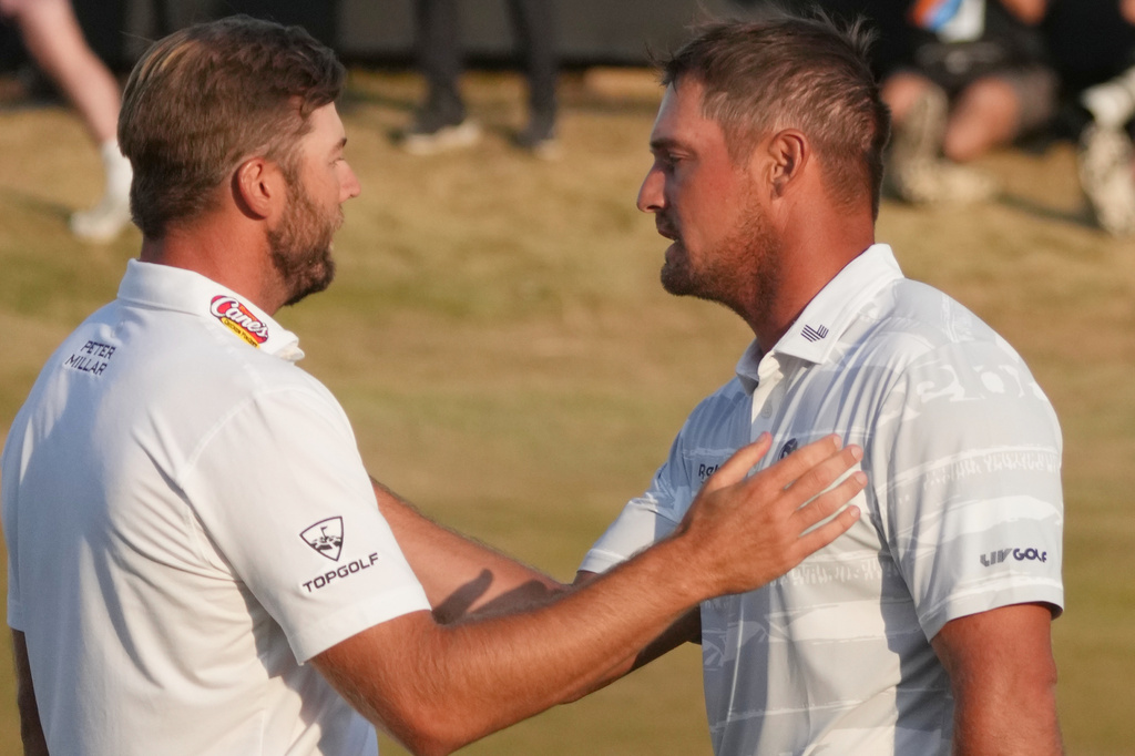 Sam Burns of the United States, left and Bryson DeChambeau of the United States shake hands on the 18th green after completing their third round during the third day of the British Open Golf championships at Royal Birkdale golf club, in Southport, England, Saturday, July 18, 2026. (AP Photo/Jon Super)