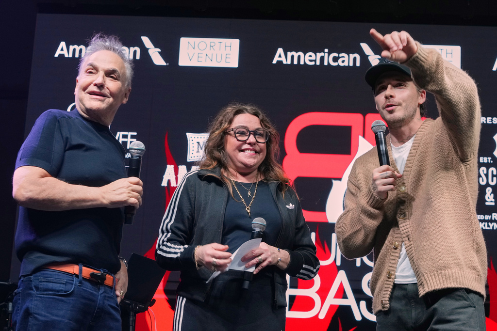 Rachael Ray and Lee Schrager, the founder of the South Beach Wine and Food Festival, listen to Brooklyn Beckham during the Burger Bash Friday, Feb. 20, 2026, in Miami Beach, Fla. (AP Photo/Marta Lavandier)
