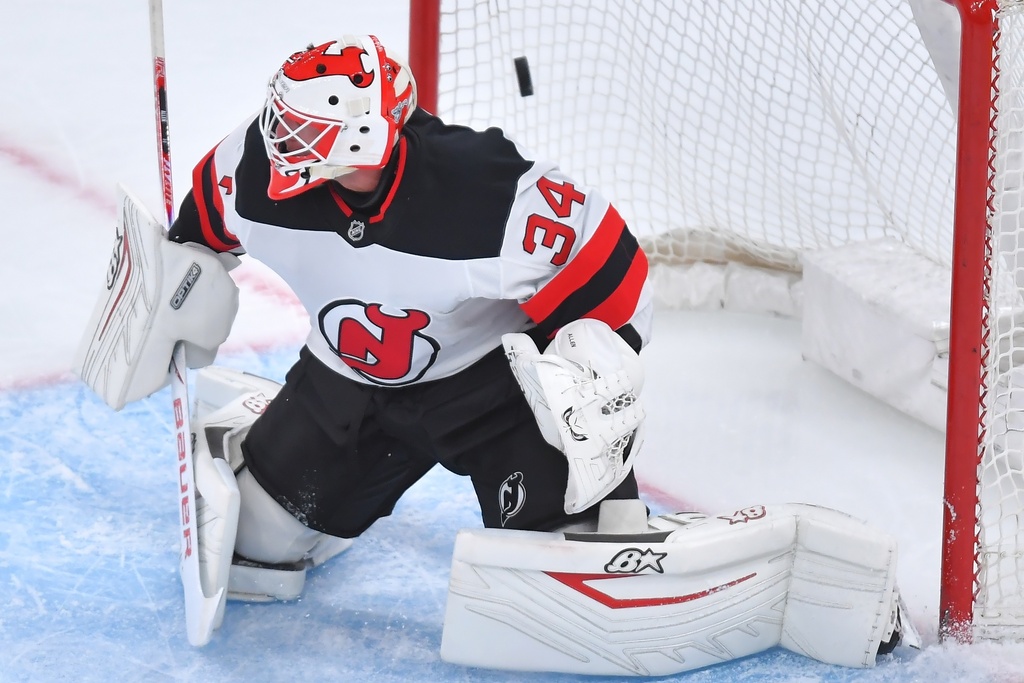 New Jersey Devils goaltender Jake Allen tries to defend as a shot by Boston Bruins center Fraser Minten flies into the net for a goal in the first period of an NHL hockey game, Saturday, Dec. 6, 2025, in Boston. (AP Photo/Steven Senne)
