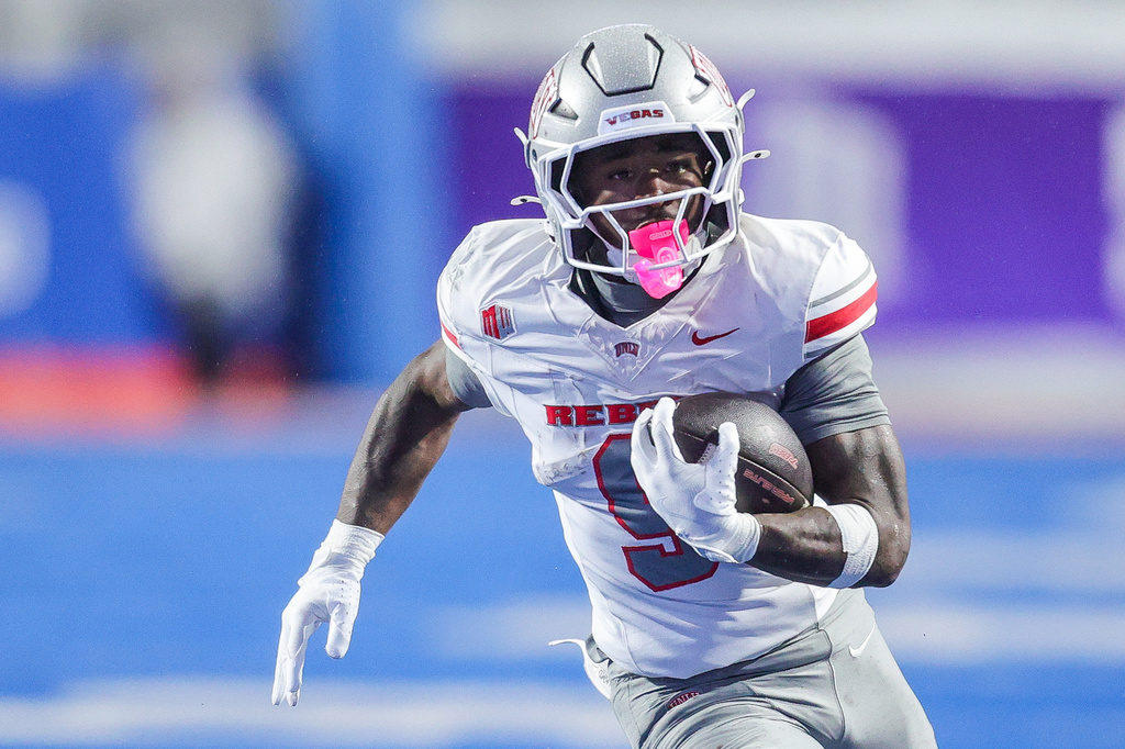 FILE - UNLV running back Jai'Den Thomas (9) runs with the ball against Boise State in the first half of the Mountain West championship NCAA college football game, Dec. 5, 2025, in Boise, Idaho. (AP Photo/Steve Conner, File)