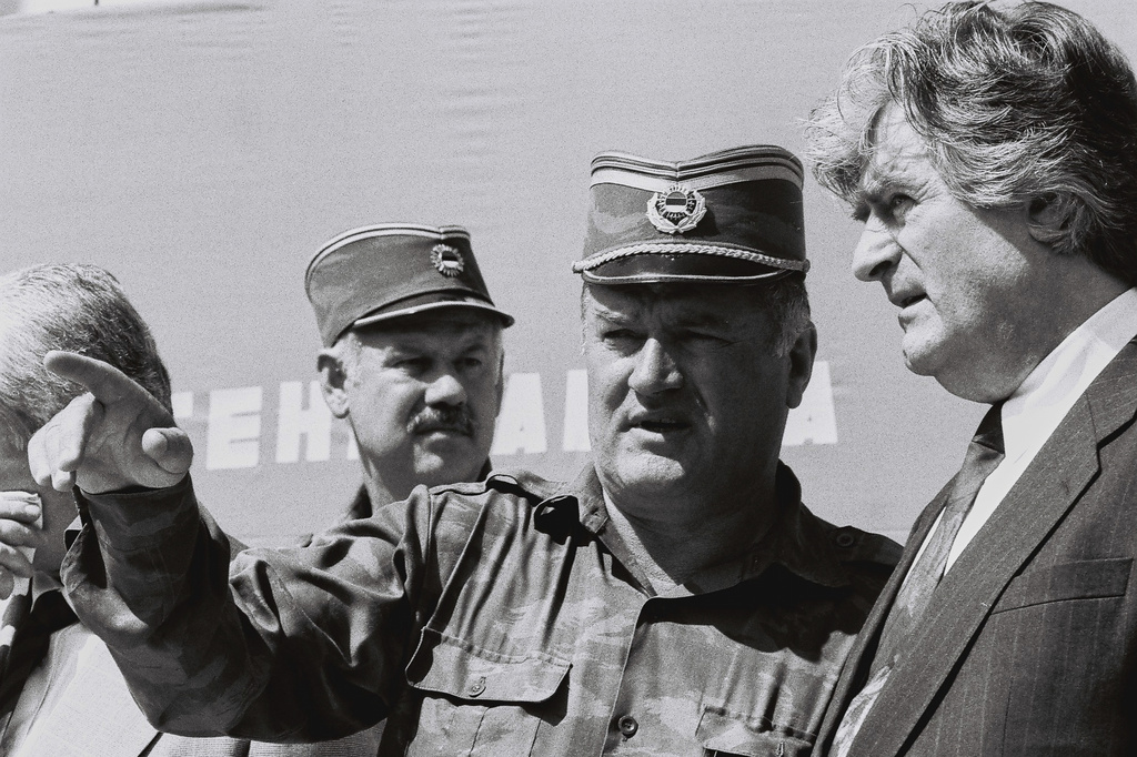 FILE - Bosnian Serb General Ratko Mladic, center, speaks with Bosnian Serb President Radovan Karadzic, right, in the Bosnian town of Banja Luka, in 1994. (AP Photo/Radivoje Pavicic, File)