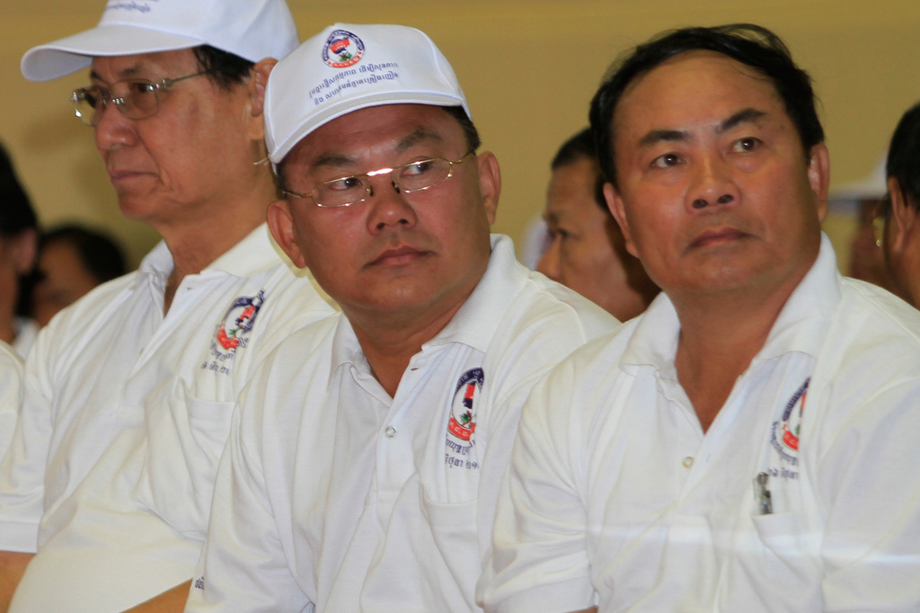 FILE -Cambodian tycoons, Senator Kok An, right, Ly Yong Phat, second from right, Lao Meng Khin, center, sit as they attend a ceremony to mark International Anti-Drug Day in Phnom Penh Cambodia, T, June 26, 2012. (AP Photo/Heng Sinith, File)