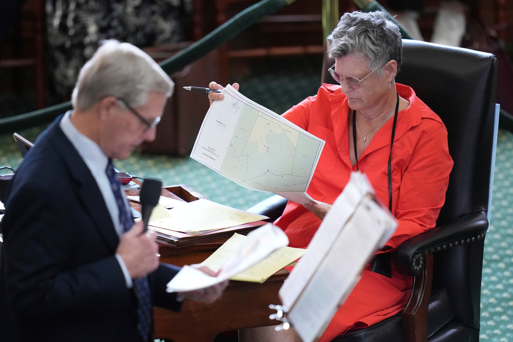 FILE - Texas state Sen. Sarah Eckhardt, D-Austin, right, listens as Sen. Phil King, R-Weatherford, speaks in favor of a bill before a vote on a redrawn U.S. congressional map during a special session in the Senate Chamber at the Texas Capitol in Austin, Texas, Aug. 22, 2025. (AP Photo/Eric Gay, File)