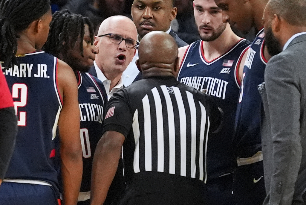 UConn head coach Dan Hurley, third from left, talks to a referee during the first half of an NCAA college basketball game against DePaul in Chicago, Sunday, Dec. 21, 2025. (AP Photo/Nam Y. Huh)
