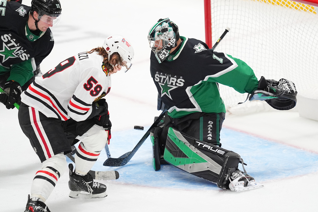 Dallas Stars goaltender Casey DeSmith (1) stops a shot by Chicago Blackhawks left wing Tyler Bertuzzi (59) during the third period of an NHL hockey game Sunday, March 8, 2026, in Dallas. (AP Photo/Julio Cortez)