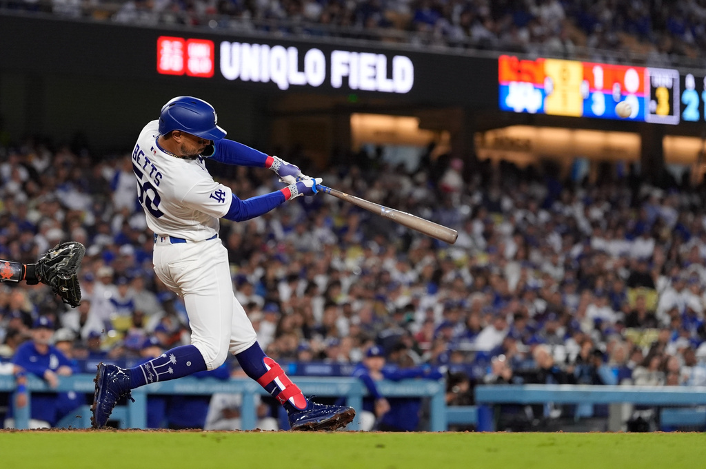 Los Angeles Dodgers' Mookie Betts hits a solo home run during the third inning of a baseball game against the San Francisco Giants, Wednesday, May 13, 2026, in Los Angeles. (AP Photo/Mark J. Terrill)