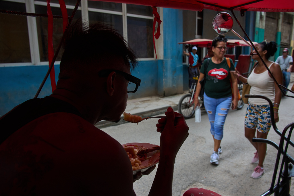 A pedicab driver eats from his bike during a blackout in Havana, Cuba, Monday, July 6, 2026. (AP Photo/Ramon Espinosa)