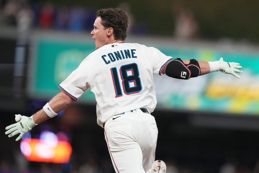 Miami Marlins' Griffin Conine (18) reacts after hitting a walk off single to score Heriberto Hernández and defeat the Philadelphia Phillies in the the ninth inning of a baseball game, Monday, July 27, 2026, in Miami. (AP Photo/Lynne Sladky)