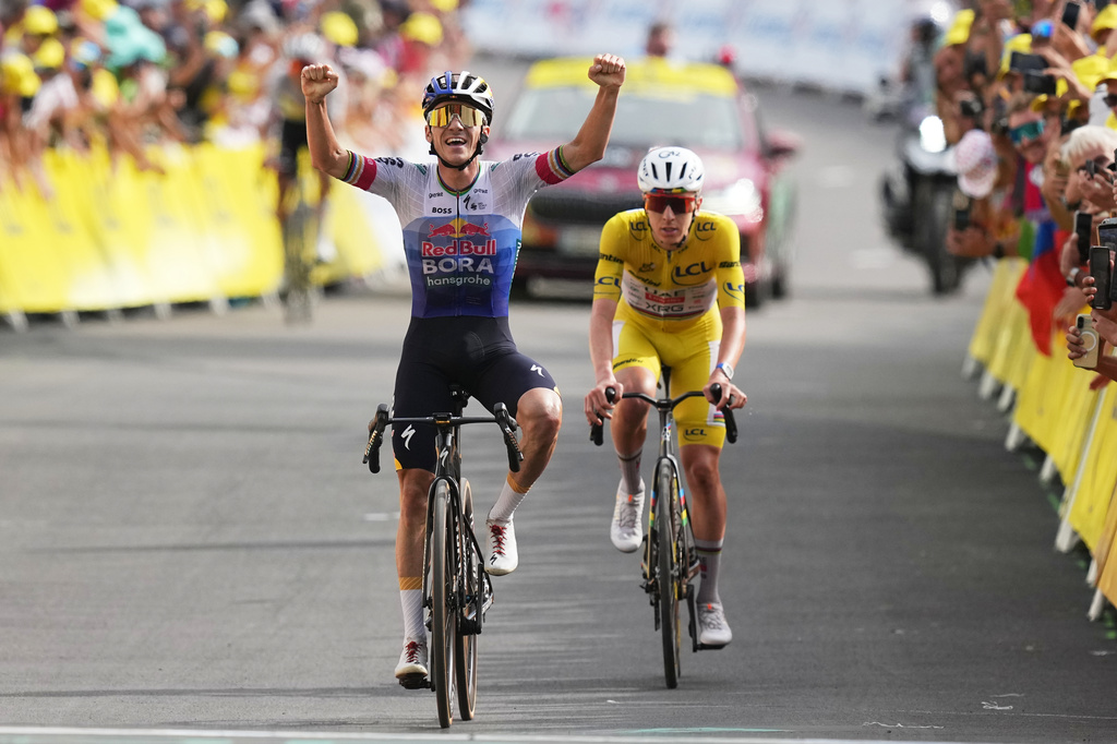 Belgium's Remco Evenepoel celebrates as he crosses the finish line ahead Slovenia's Tadej Pogacar to win the fifteenth stage of the Tour de France cycling race, from Champagnole to the Plateau de Solaison, France, Sunday, July 19, 2026. (AP Photo/Thibault Camus)