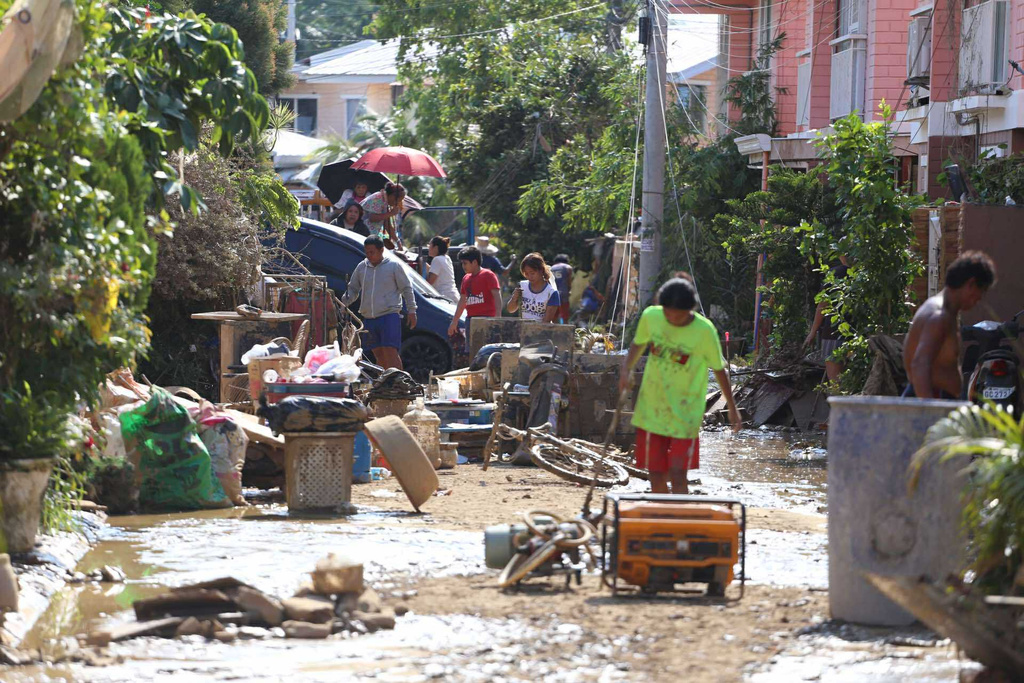 Residents clear their flood damaged homes caused by Typhoon Kalmaegi in Liloan, Cebu province, central Philippines on Thursday, Nov. 6, 2025. (AP Photo/Jacqueline Hernandez)