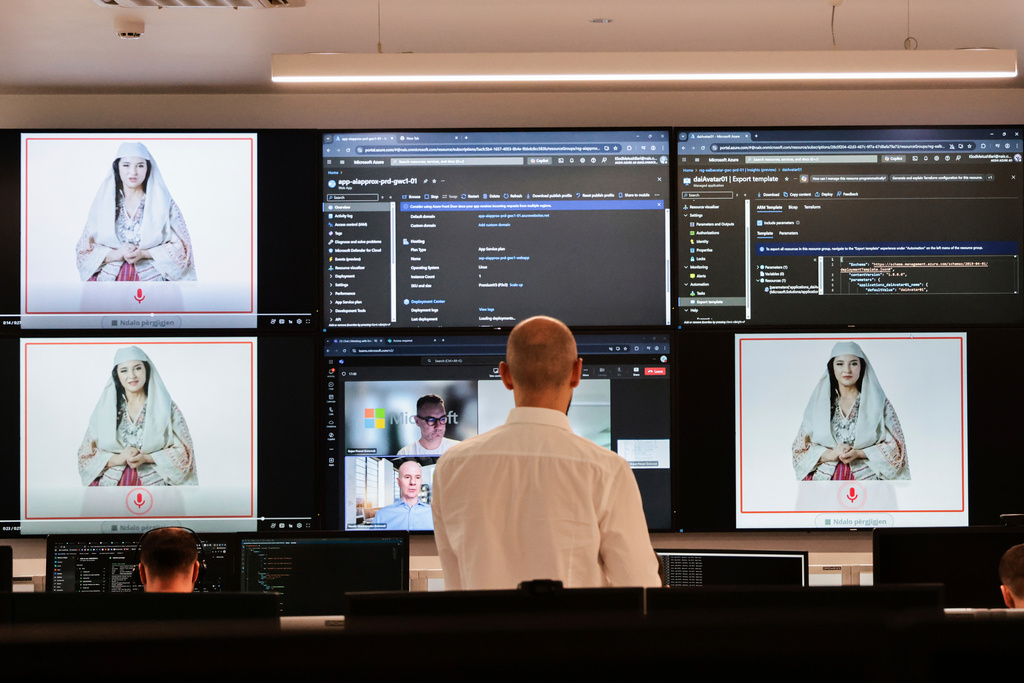 FILE - Albanian experts work at the National Agency for Information Society as an artificial intelligence "minister" Diella, whose name means "Sun" in Albanian, is seen on the screens in Tirana, Albania, Friday, Sept. 12, 2025. (AP Photo/Vlasov Sulaj, File)