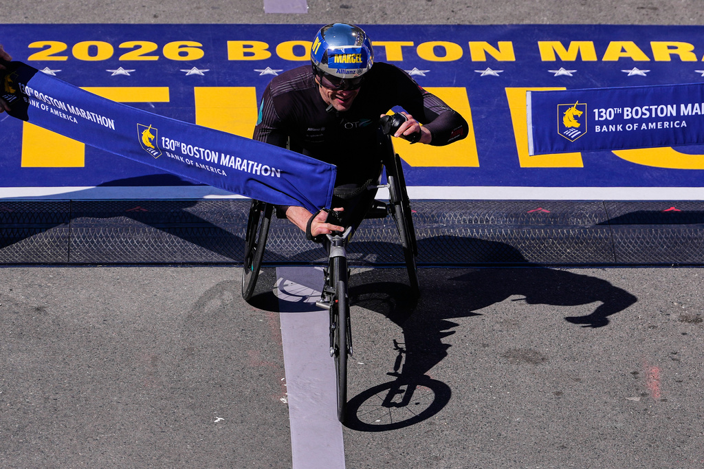 Marcel Hug, of Switzerland, breaks the tape to win the men's wheelchair division at the Boston Marathon, Monday, April 20, 2026, in Boston. (AP Photo/Charles Krupa)