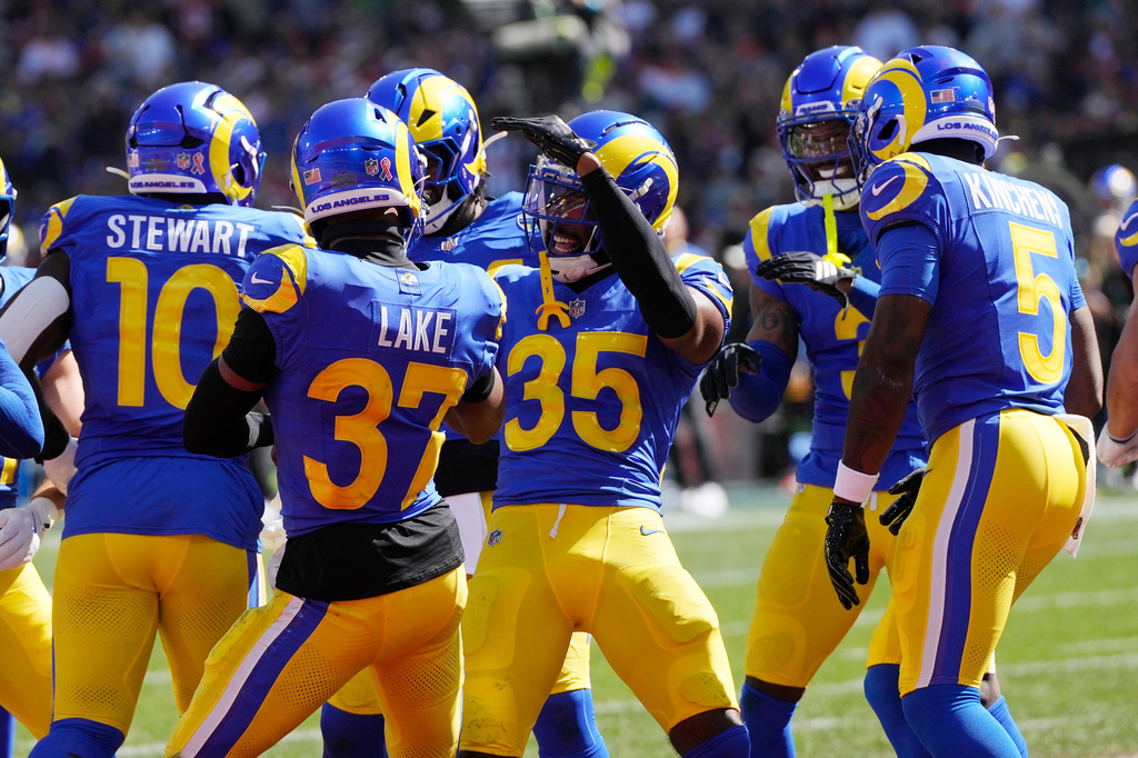 Los Angeles Rams safety Quentin Lake (37) and cornerback Jaylen Watson (35) celebrate after Lake intercepted a pass against the San Francisco 49ers in the first half of an NFL football game in Melbourne, Australia, Friday, Sept. 11, 2026. (AP Photo/Doug Benc)