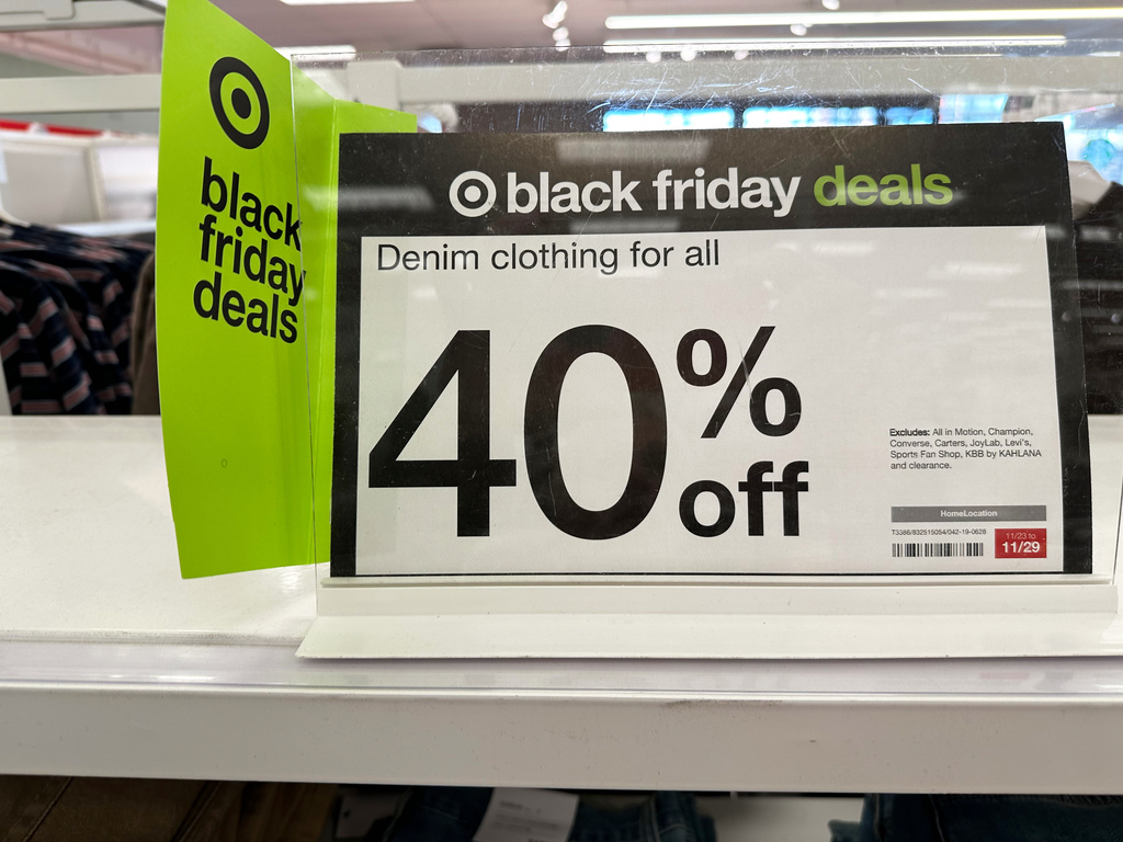 Signs denote Black Friday deals already available on clothing in a Target store, Wednesday, Nov. 26, 2025, in southeast Denver. (AP Photo/David Zalubowski)