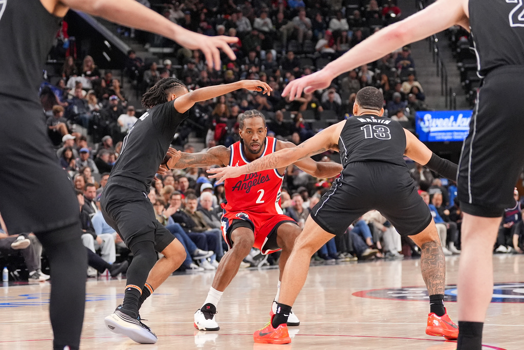 Los Angeles Clippers forward Kawhi Leonard (2) is defended by Brooklyn Nets forward Tyrese Martin (13) and forward Ziaire Williams (1) during the second half of an NBA basketball game Sunday, Jan. 25, 2026, in Inglewood, Calif. (AP Photo/Jae C. Hong)