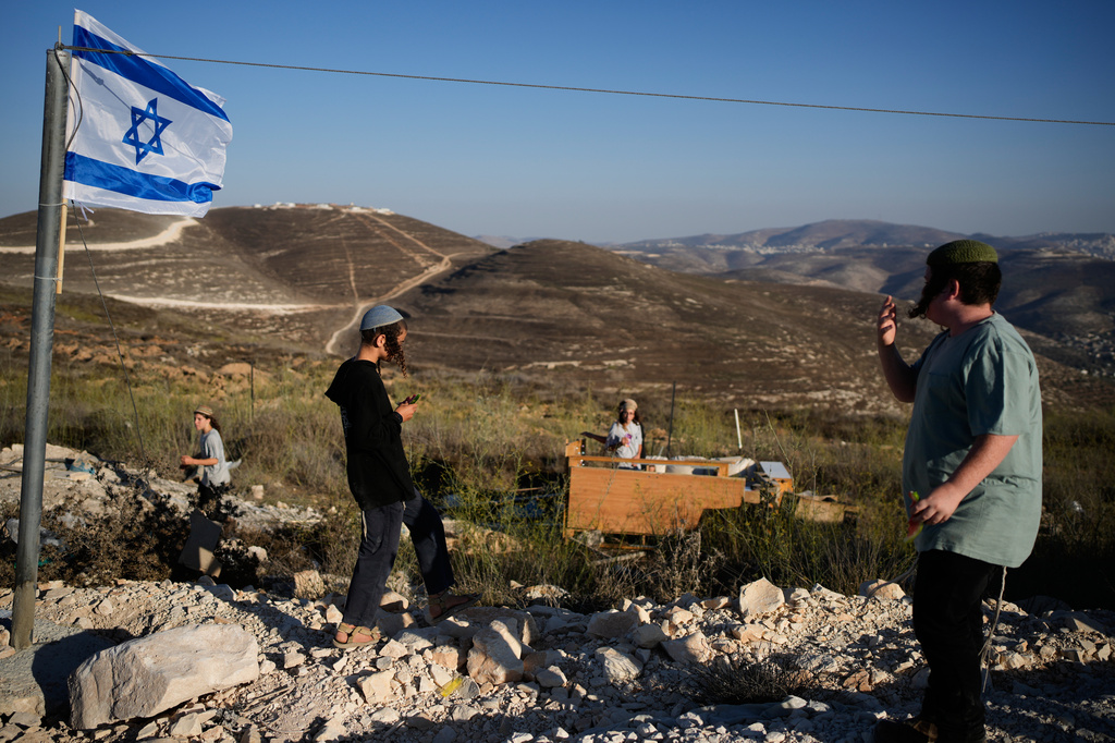 Israeli settlers gather to celebrate the inauguration of a newly built synagogue at the occupied West Bank outpost of Homesh, Wednesday, Sept. 16, 2026. (AP Photo/Ohad Zwigenberg)