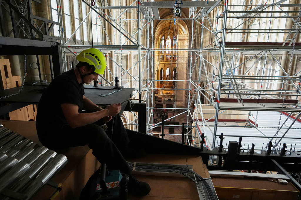 FILE - A worker adjusts cables during the installation of a new organ at Prague's St. Vitus Cathedral that is coming to its final stages in Prague, Czech Republic, Tuesday, July 22, 2025. (AP Photo/Petr David Josek, File)
