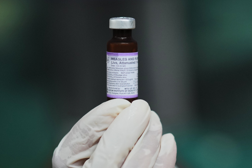 A health worker shows a vial of measles-rubella vaccine, during a vaccination campaign in Sumenep on Madura Island, Indonesia, Monday, Sept. 8, 2025. (AP Photo/Dita Alangkara)
