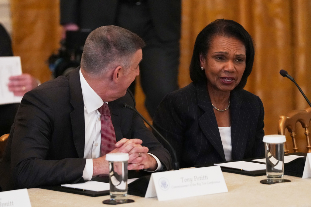 Big Ten Conference commissioner Tony Petitti, left, talks with former U.S. Secretary of State Condoleezza Rice before a roundtable discussion about college sports in the East Room of the White House, Friday, March 6, 2026, in Washington. (AP Photo/Julia Demaree Nikhinson)